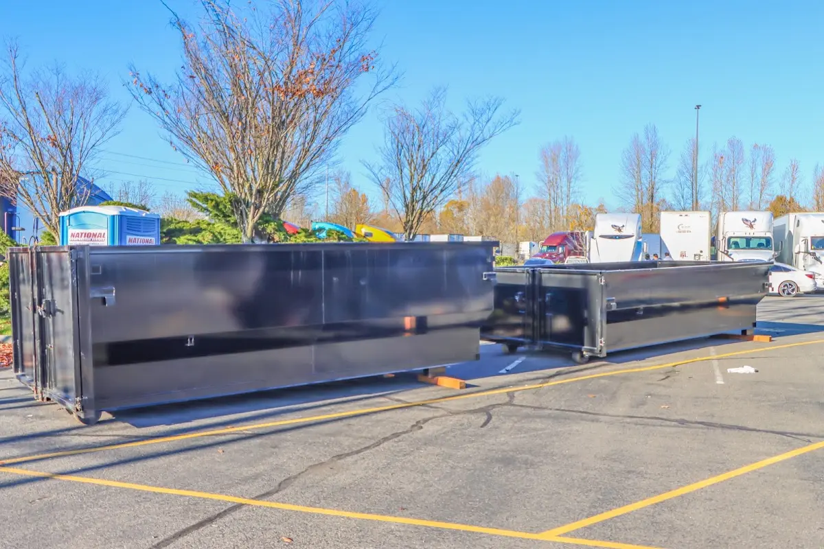 Professional dumpster rental service with roll-off container on residential driveway in Laramie